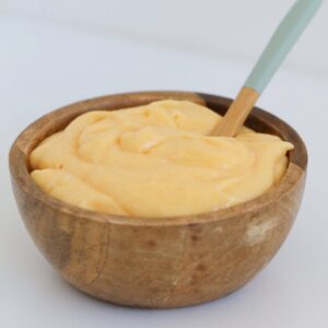 Lemon curd in a wooden bowl.